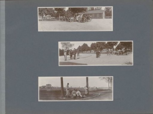 Soldiers near cars in France, wooden cottages in the background