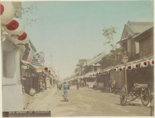Street in Yokohama with passers-by, shops, lanterns and carts