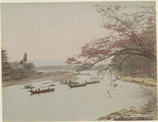 View of a river with floating logs and boats in Arashiyama