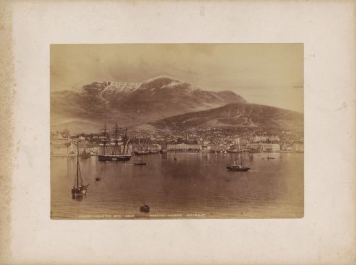 View of Hobart with ships in the harbour and mountains in the background