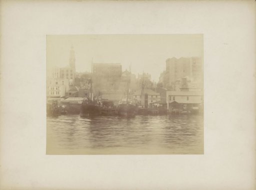 View of buildings, businesses and ships in the harbour of (probably) Sydney