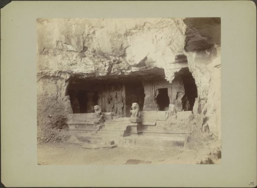 Entrance of a cave temple on Elephanta with lion statues and reliefs