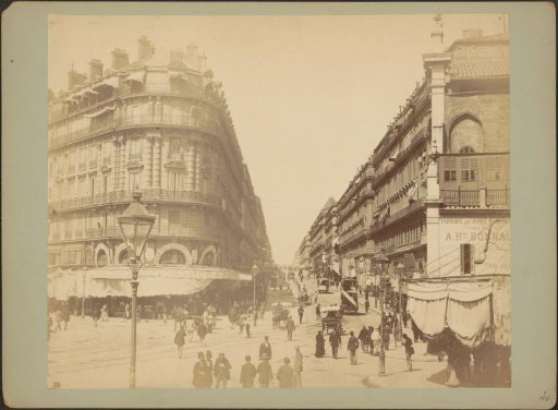Street scene in Marseille with horse trams, shops and passers-by