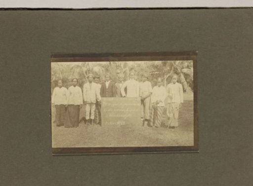 Leprosy colony Danaradja: staff posing behind a sign