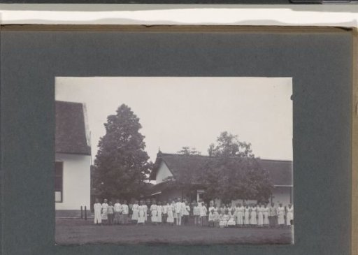 Group portrait of Indonesian men and women and one European man, presumably staff of a hospital in the Dutch East Indies