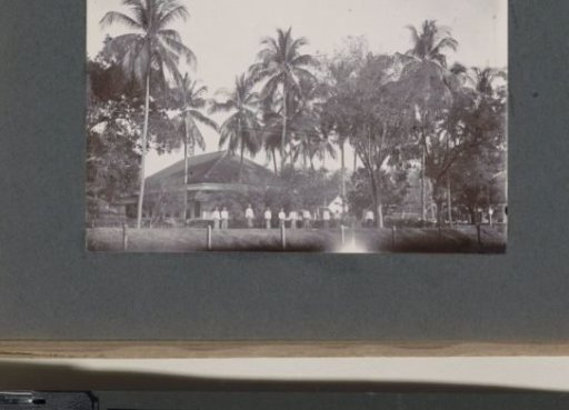 Men and women standing side by side on a road, probably on the grounds of a hospital in the Dutch East Indies
