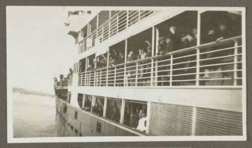 Waving passengers on board a ship