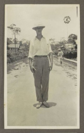 Man wearing a tropical helmet posing on a road