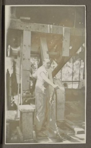 Man operating a machine with a lever