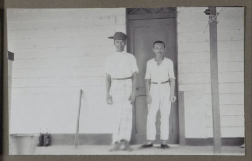 Two men standing before a door