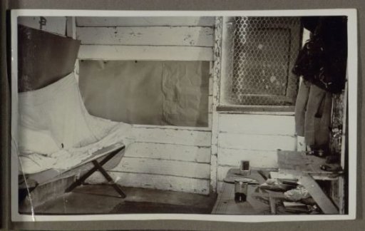 Room with utensils and clothing, possibly a corner of a bedroom