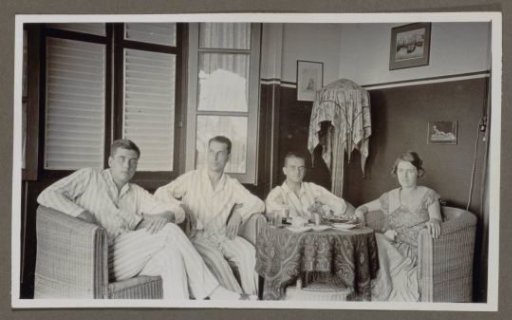 Three men and a woman around a table