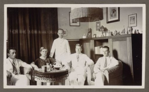 Four men and a woman around a table