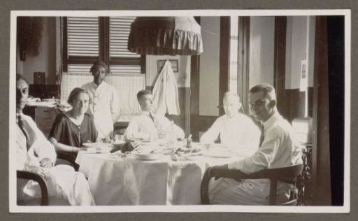 Indonesian servant, European men and a woman around a table