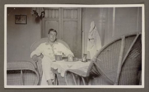 Smoking man seated behind a table