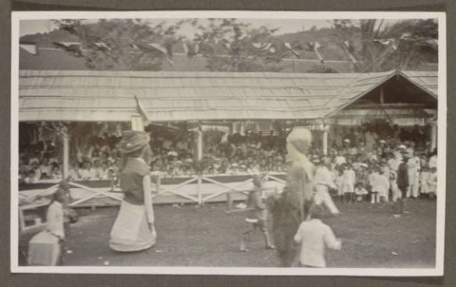 Parade with giant puppets before a tribune
