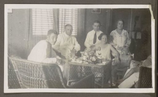 Men, women and a child around a table with wine glasses