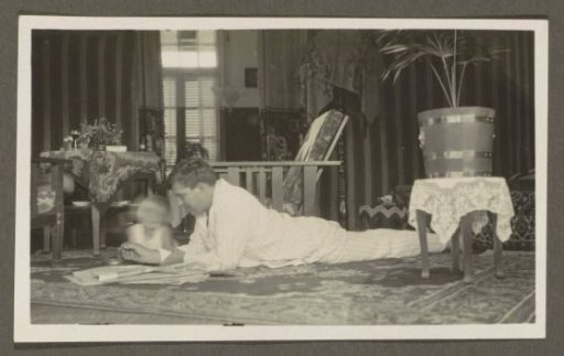 Man and child lying on a carpet
