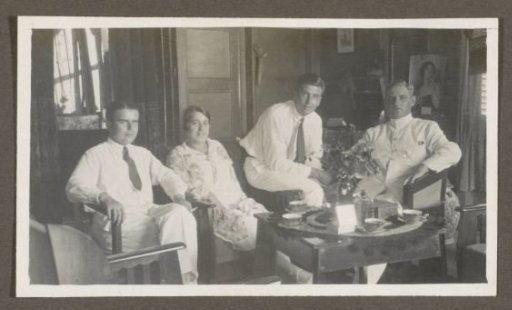 Three men and a woman around a table