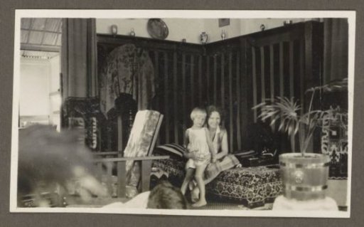 Woman with a child on her lap on a sofa