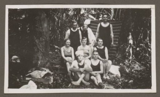 Group of men and women in swimwear in a forest
