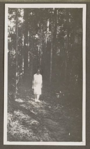 Woman posing on a forest path