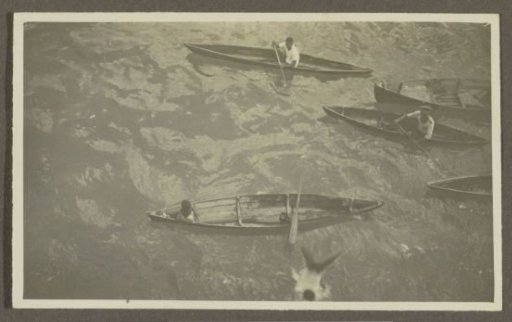 Boys in wooden boats