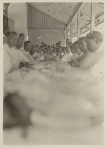 Men sitting at a long table