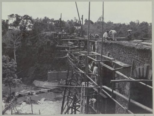 Construction work on the western abutment and demolition of the trestle on the eastern abutment on the banks of the Kali Brantas south of Malang (Photo XIX)