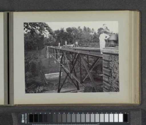 Javanese workers on a finished bridge over the Kali Brantas south of Malang, in the foreground a Dutchman indicated as 'Mr. Van Leeuwen' (Photo XXI)