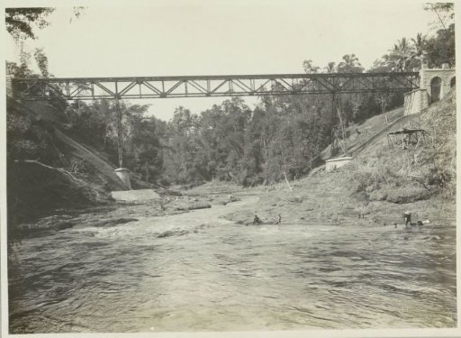 View of abutments, piers and span of a bridge over the Kali Brantas south of Malang