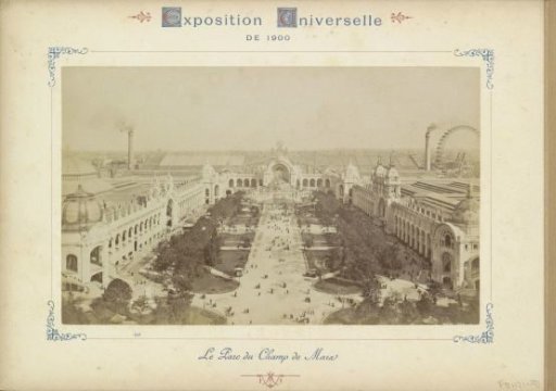 View of the Parc du Champ de Mars with the Water Tower, the Palais de l'Electricité, smoking chimneys and a Ferris wheel in the background