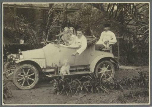 Dutch Bergsma family and Indonesian man in car in Sumatra, dog on the running board