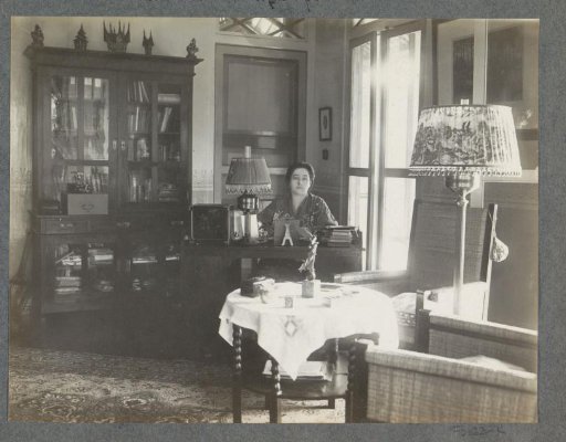 Gerda Bergsma behind a desk in a residence in Sumatra