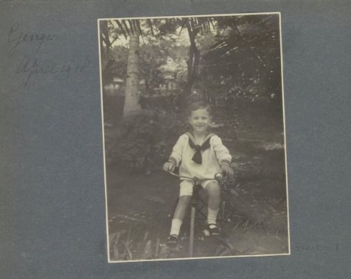 Georges Bergsma on a tricycle in a garden in Sumatra