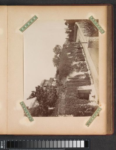 Villa with a front garden, with a man in uniform in the foreground, probably in Nice