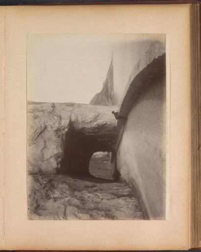 Road and tunnel along the coast from Nice to Monaco, with a man looking out to sea in the foreground