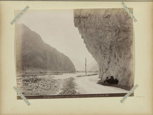 Group of men under overhanging rocks on a military road near Balta in Georgia