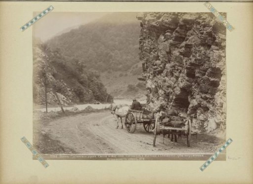 Horse-drawn carts on a military road along a river in Georgia