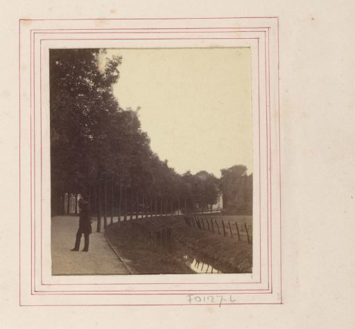 Unknown man posing on a street along a ditch in The Hague