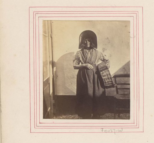 Portrait of an unknown Scheveningen fisherwoman with a basket in her hand
