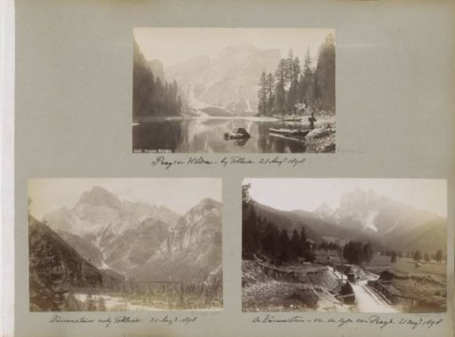 Man with a scoop net by the Pragser Wildsee with mountains in the background
