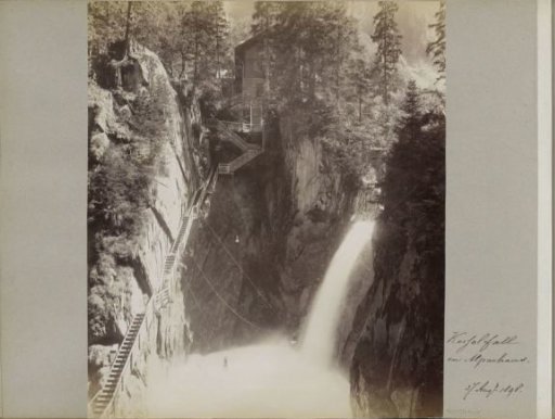 View of the Kesselfall in the Kapruner Tal with wooden stairs and a house on the left