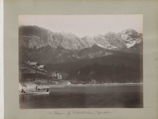 Company in a rowing boat on the Eibsee near Partenkirchen with snow-capped mountain peaks in the background