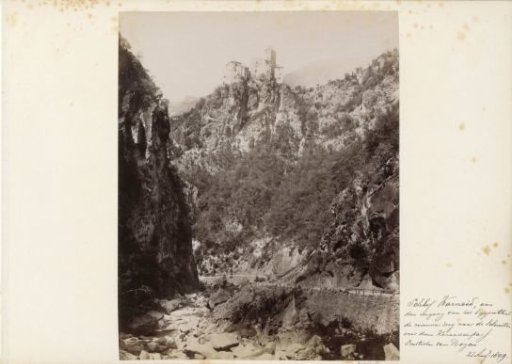 Mountain gorge and road in the Eggental with Karneid Castle on the rocks