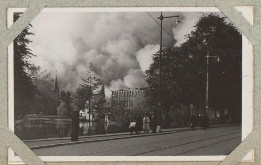 View of the Westzeedijk in Rotterdam with smoke clouds in the background
