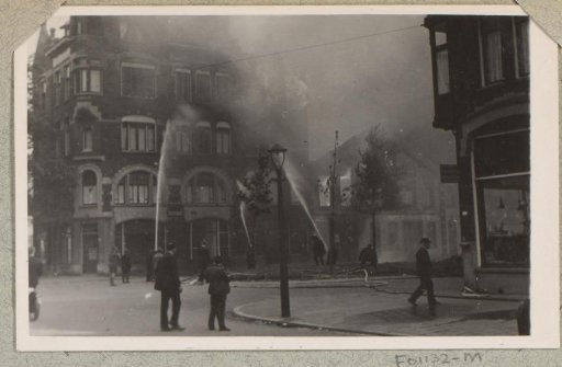 Extinguishing a fire, after the bombing, in the Infirmerstraat in Rotterdam