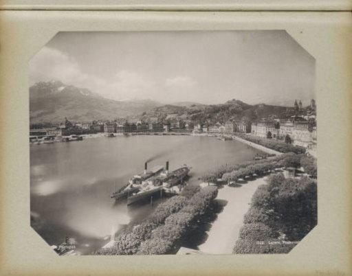 View of Lucerne with the promenade and moored boats in the foreground and the railway station in the left background