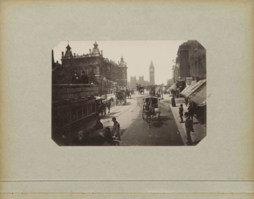 Westminster Bridge Road with horse-drawn carriages and passers-by, viewed towards the Houses of Parliament and Big Ben in London