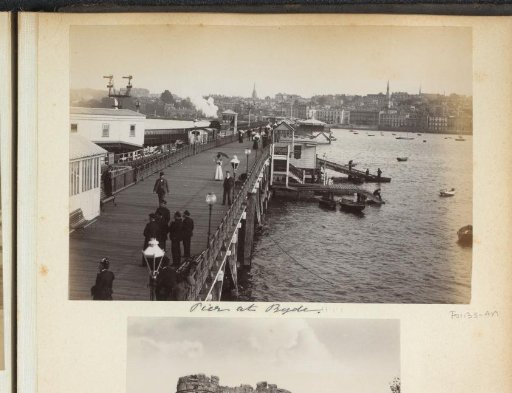 Walkers on Ryde Pier, with the Town of Ryde on the Isle of Wight in the Background